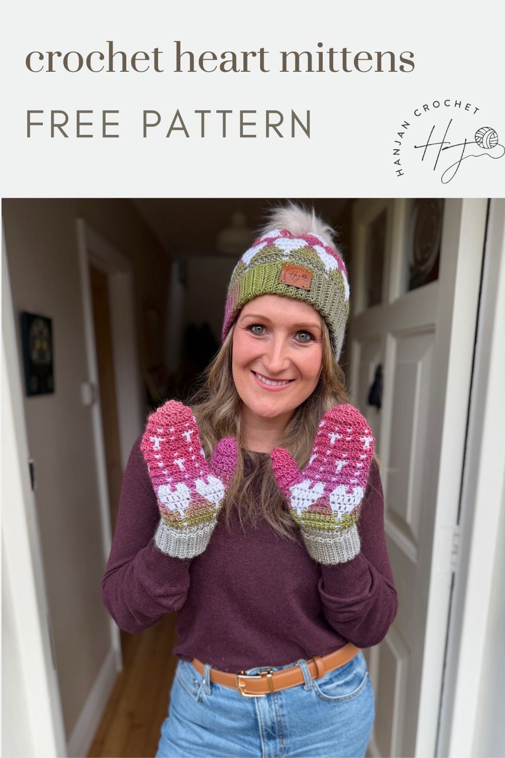 A woman wearing a matching knit hat and crochet heart mittens stands in a hallway, smiling at the camera. The text reads "crochet heart mittens FREE PATTERN".