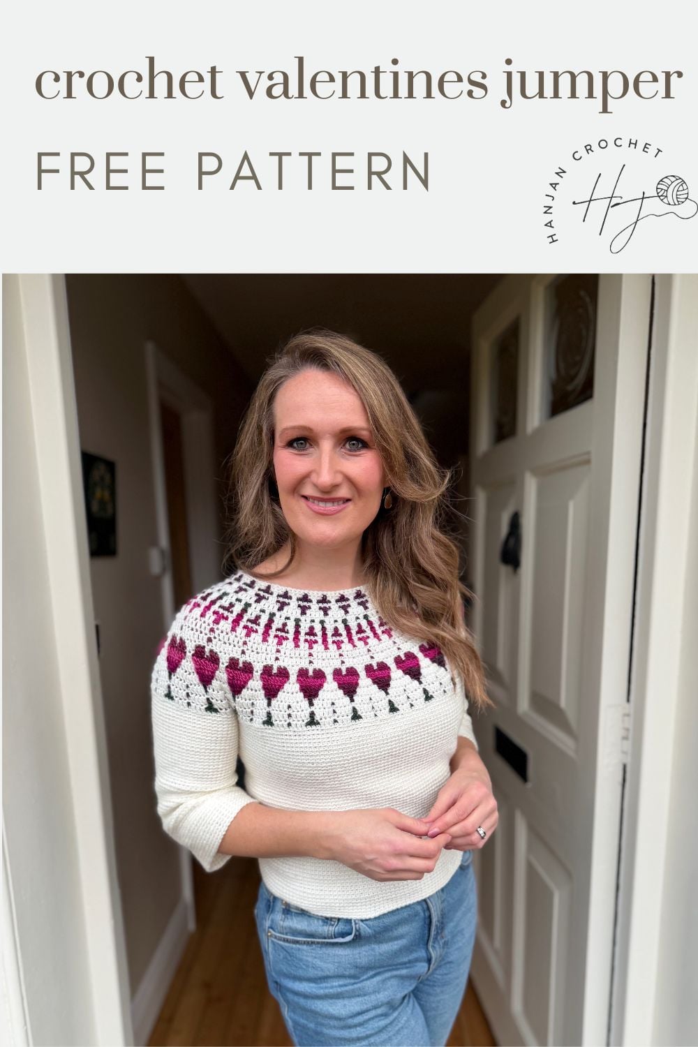 Woman stands in a doorway wearing a white crochet jumper with a red and pink heart pattern. Text on image reads "crochet valentines jumper FREE PATTERN.