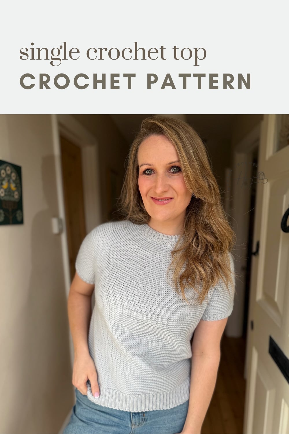 Woman wearing a light gray short-sleeve crochet top, standing indoors. Text above reads "single crochet top CROCHET PATTERN.