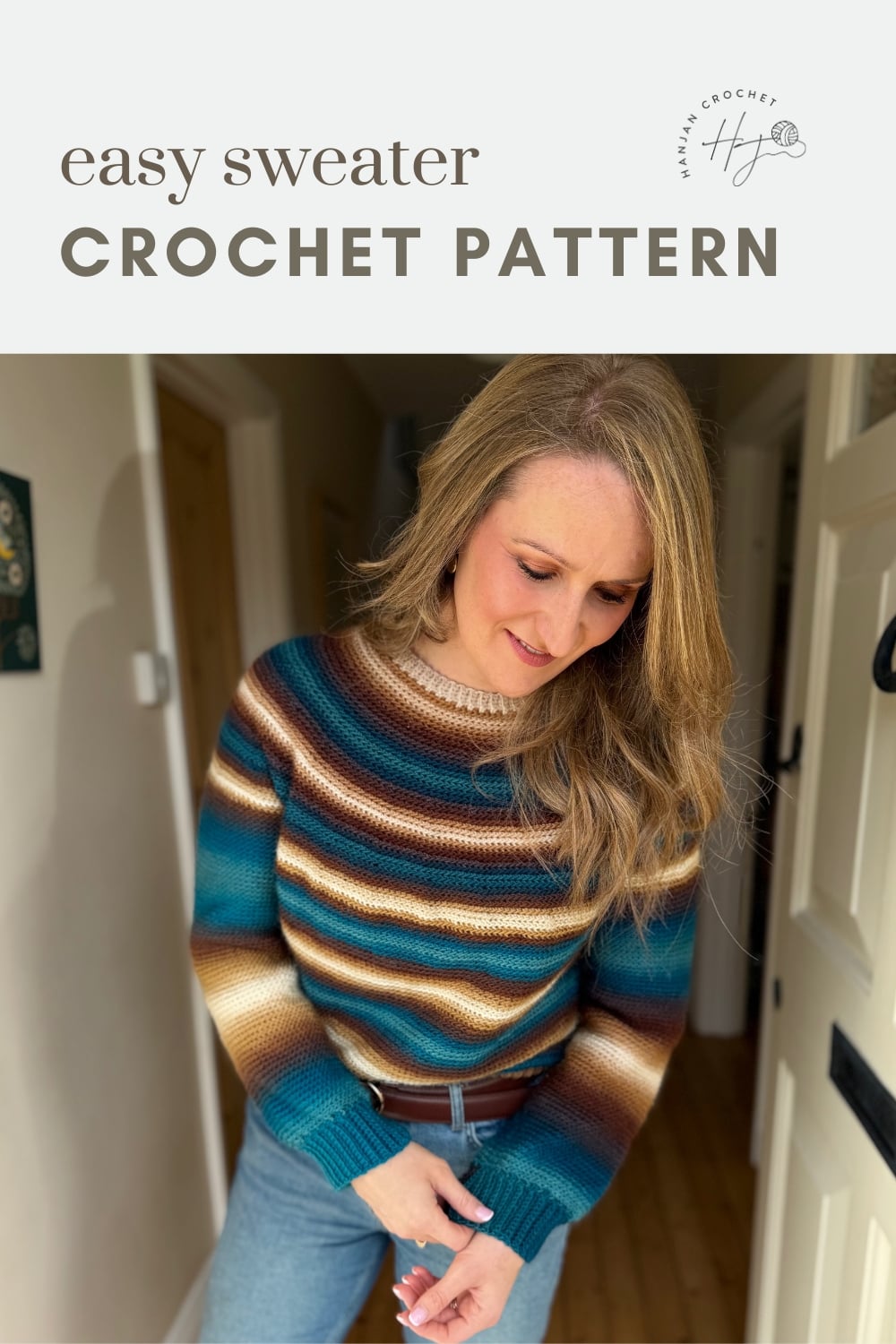 A woman wearing a striped, hand-crocheted sweater in blue, brown, and cream stands indoors; text above reads "easy sweater crochet pattern.