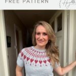 A woman stands in a hallway wearing a light gray, short-sleeved crochet sweater with a red and pink patterned yoke. Text above reads: "short-sleeved crochet sweater FREE PATTERN.