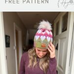 A woman wearing a pink, white, and green crochet hat with a pom-pom stands in a hallway, with text above her reading "unique crochet hat FREE Crochet Heart Hat Pattern.