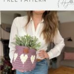 A woman holds a purple crochet basket with white heart patterns and a potted plant inside. Another similar crochet heart basket pattern is visible in the background. Text reads: "valentines crochet FREE PATTERN.