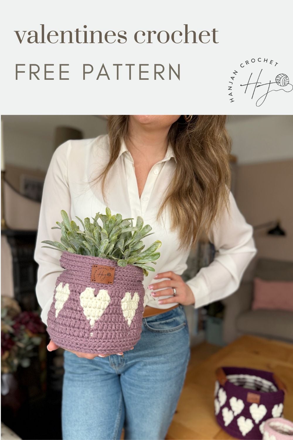 A woman holds a purple crochet basket with white heart patterns and a potted plant inside. Another similar crochet heart basket pattern is visible in the background. Text reads: "valentines crochet FREE PATTERN.