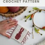 A hand holds a square crocheted coaster with a red bunny silhouette, surrounded by yarn, a basket, and a decorative branch. Text above reads, “crochet bunny coaster pattern CROCHET PATTERN.”.