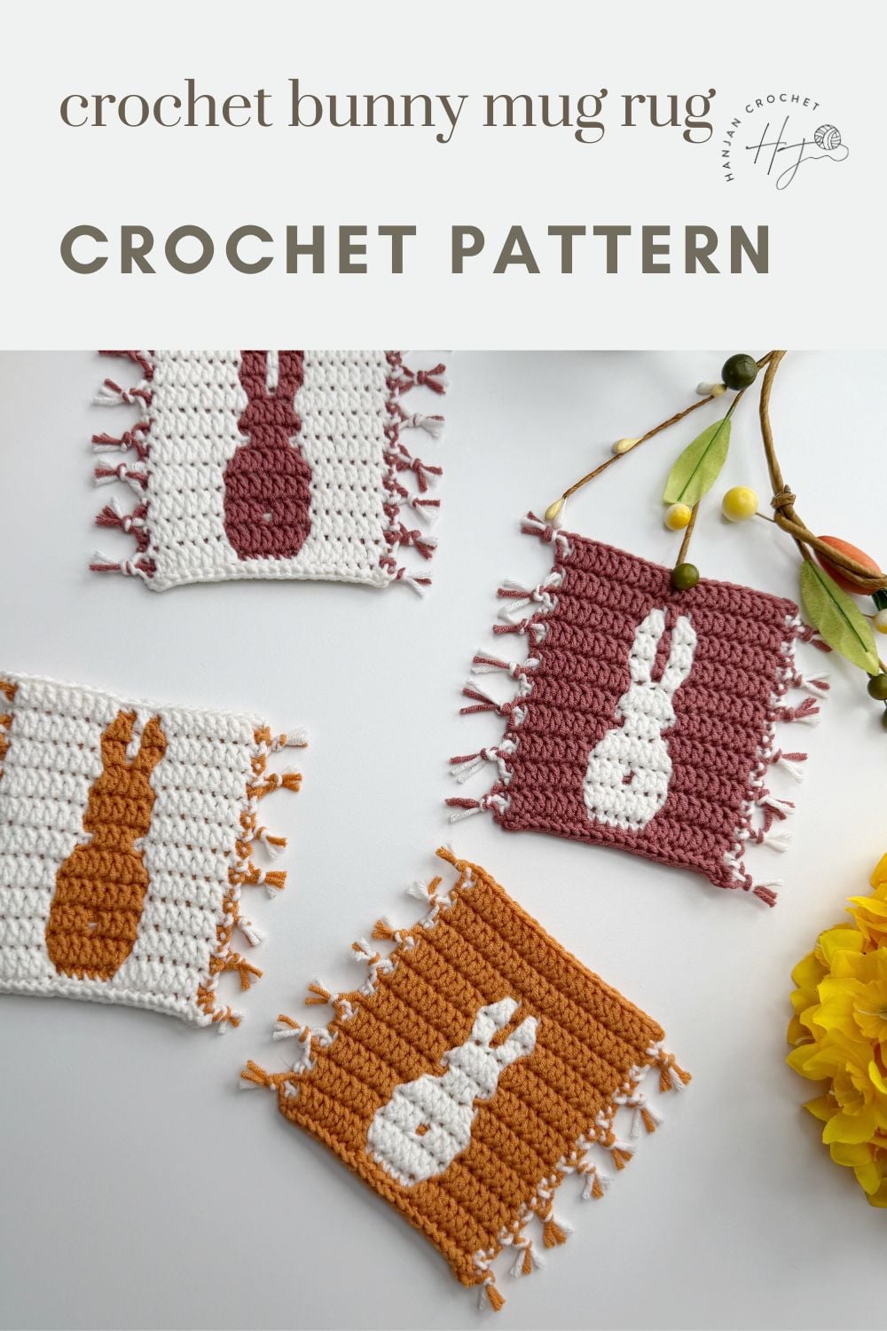 Four crocheted mug rugs with bunny silhouettes in various colors are displayed on a white surface with decorative flowers nearby. Text reads "crochet bunny coaster pattern CROCHET PATTERN.