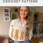 A woman stands indoors holding a crochet bunny basket pattern featuring a brown bunny design, with text above that reads "Easter bunny basket CROCHET PATTERN.