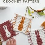 Three square crochet coasters feature bunny silhouettes in contrasting colors, displayed with a hand for scale and some decorative spring elements—perfect inspiration for your next crochet bunny coaster pattern.