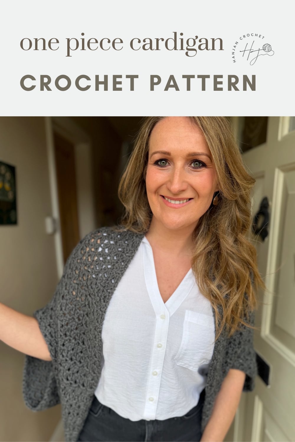 Woman wearing a grey crocheted cardigan over a white shirt, standing indoors; text above reads "one piece cardigan CROCHET PATTERN.