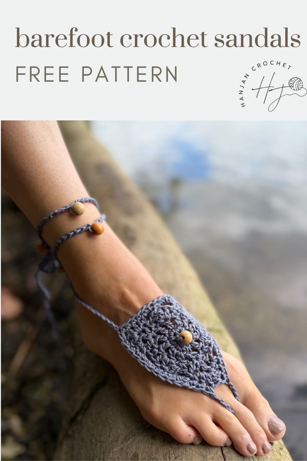 A foot wearing gray crocheted barefoot sandals with wooden beads rests on a wooden surface near water; text reads "free barefoot crochet sandals pattern.