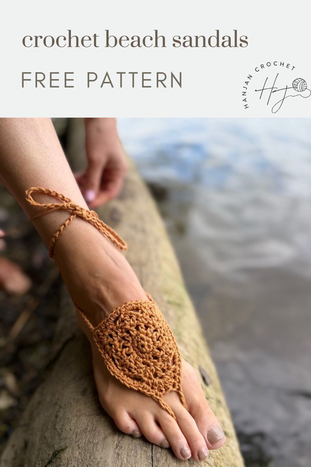 A bare foot wearing a brown crocheted beach sandal with ankle ties rests on a wooden log by the water. Text reads: "free barefoot crochet sandals pattern.