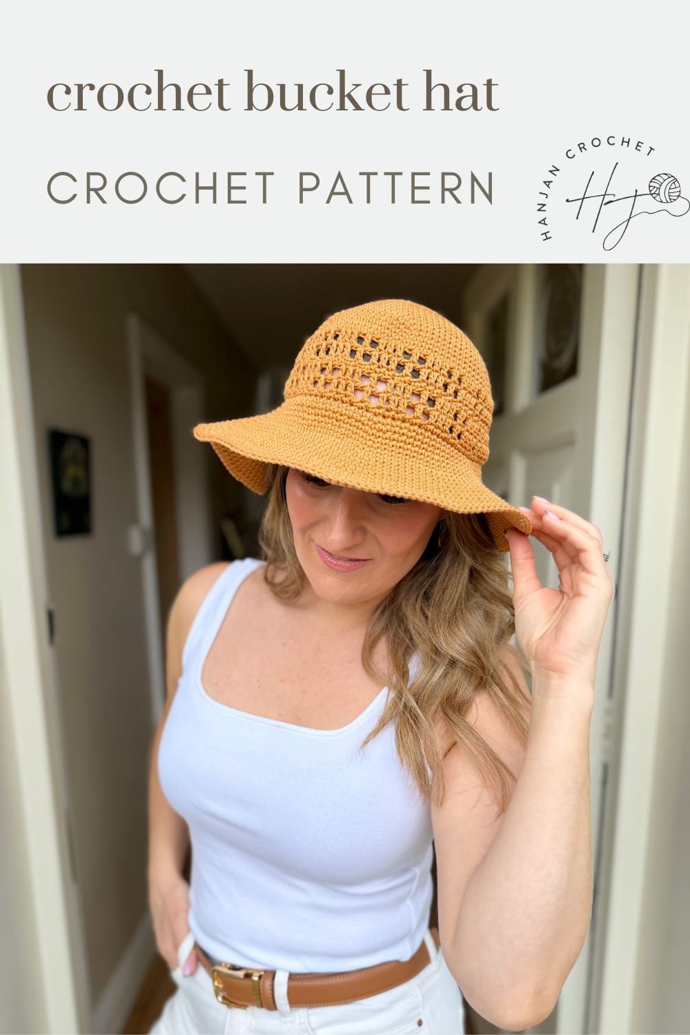 A woman wearing a crocheted bucket hat stands indoors, holding the brim. Text above reads "Free Crochet Sun Hat Pattern CROCHET PATTERN" with a logo on the top right.