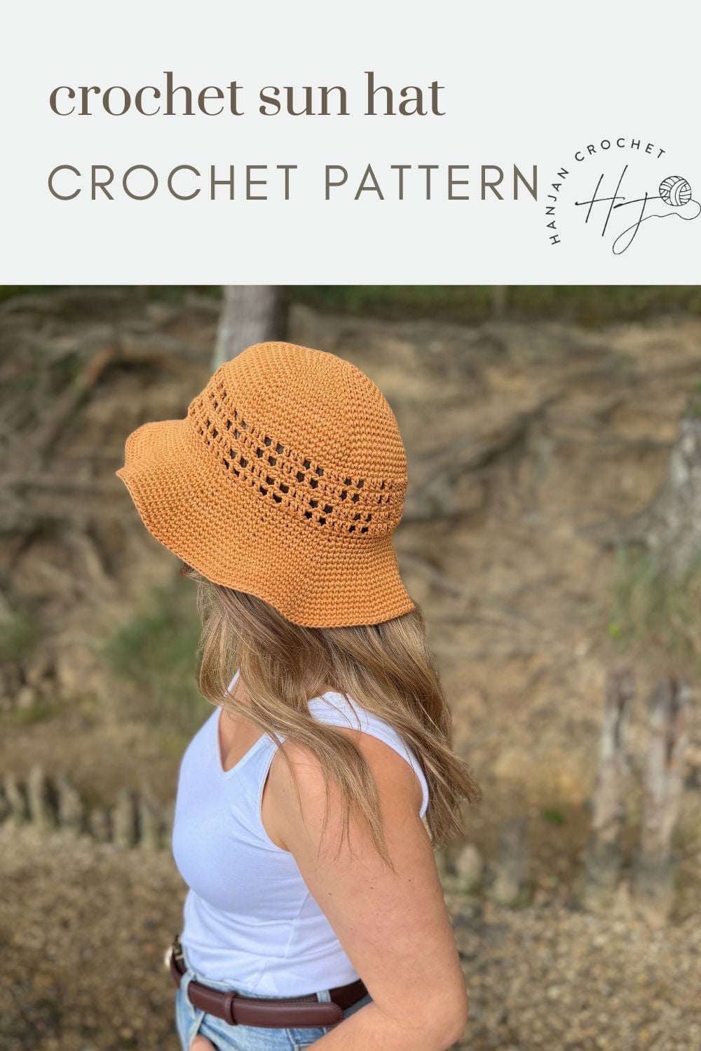 A woman wearing a crocheted orange sun hat and white tank top stands outdoors with trees and rocks in the background. Text reads "Free Crochet Sun Hat Pattern CROCHET PATTERN.