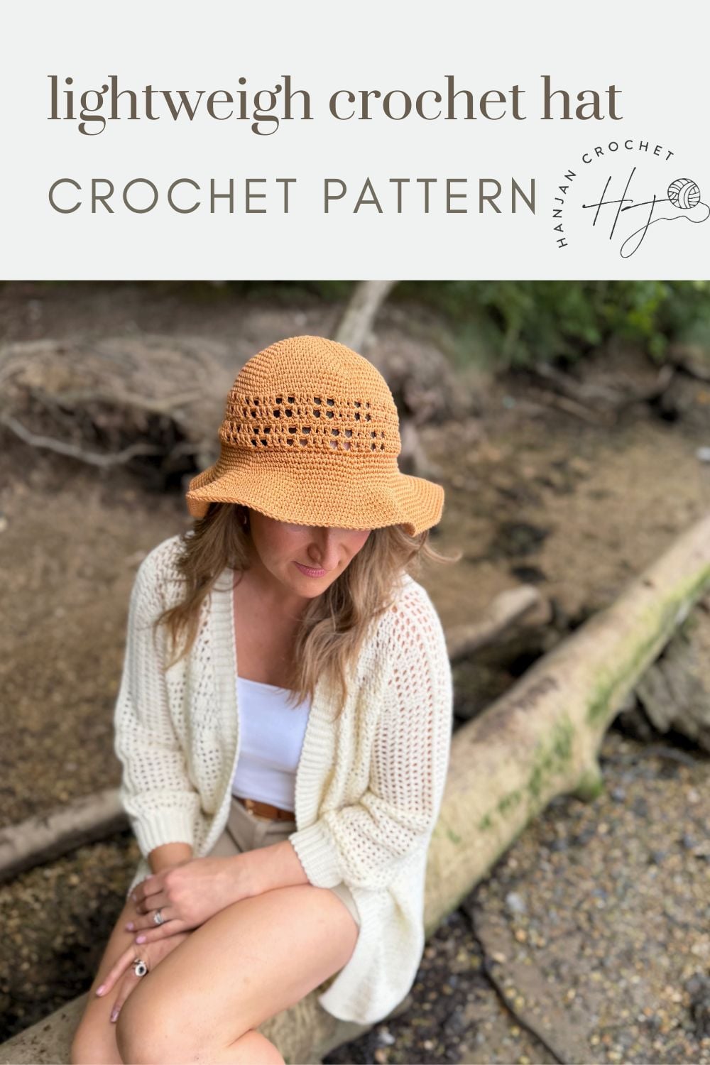 A woman wearing a light brown crochet hat and white cardigan sits on a log by the water. Text above reads "Free Crochet Sun Hat Pattern - lightweight crochet hat CROCHET PATTERN.