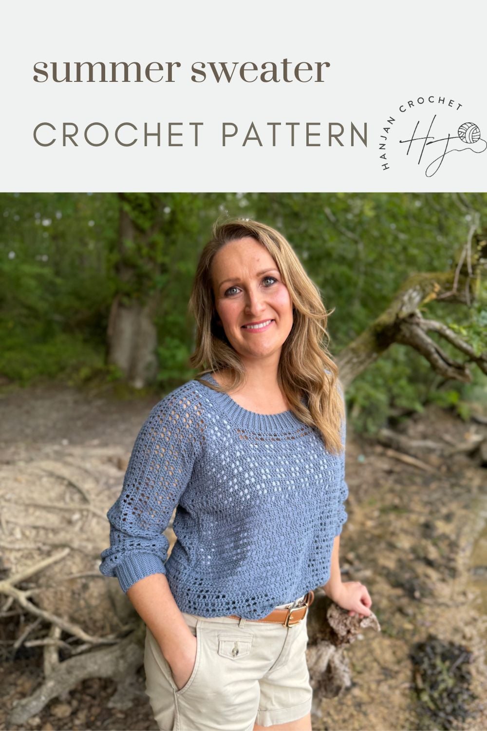 Woman wearing a light blue crocheted sweater and beige shorts stands outdoors in a wooded area. Text above reads, "summer sweater crochet pattern.