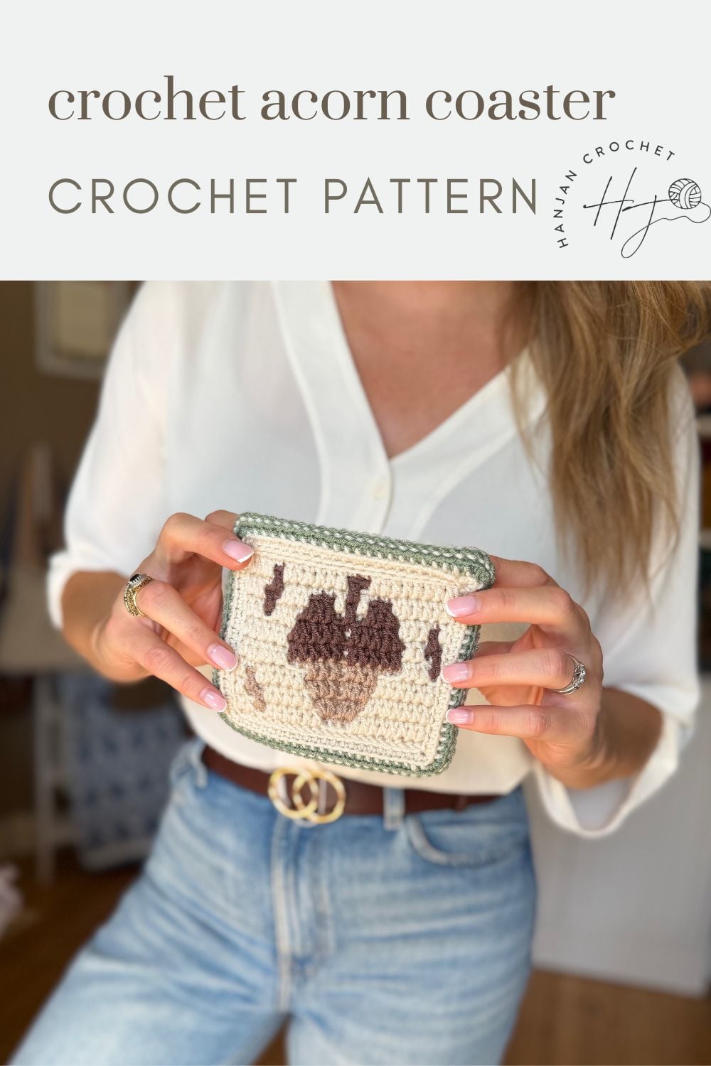 A person in a white shirt and jeans holds a crocheted square coaster with an acorn design. The image promotes an acorn crochet pattern for making charming coasters.