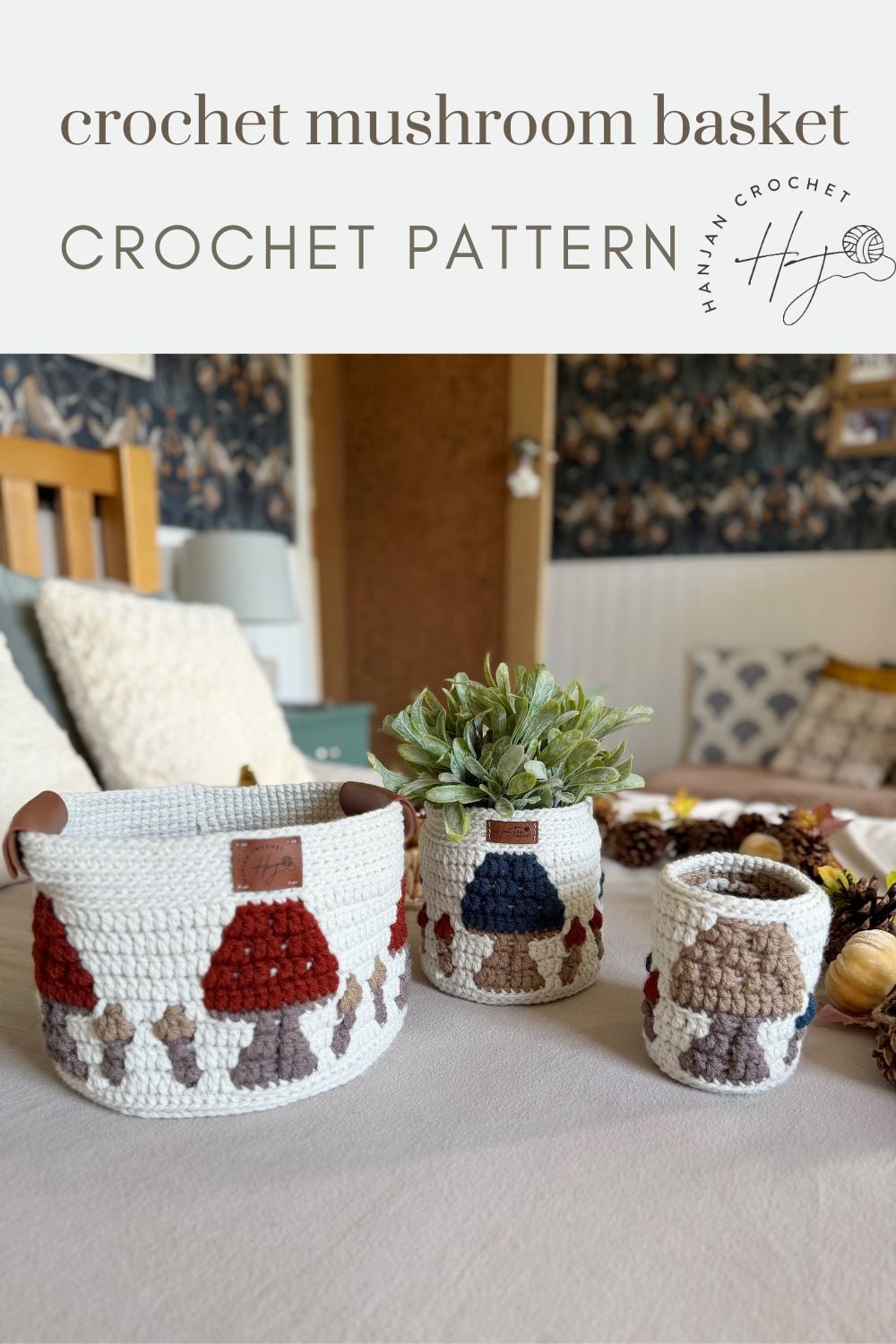 Three crocheted baskets with charming mushroom designs are displayed on a bed, accompanied by a plant and other decorative items. Text above reads “crochet mushroom basket CROCHET PATTERN.” This unique crochet storage basket pattern adds both whimsy and functionality to your home decor.