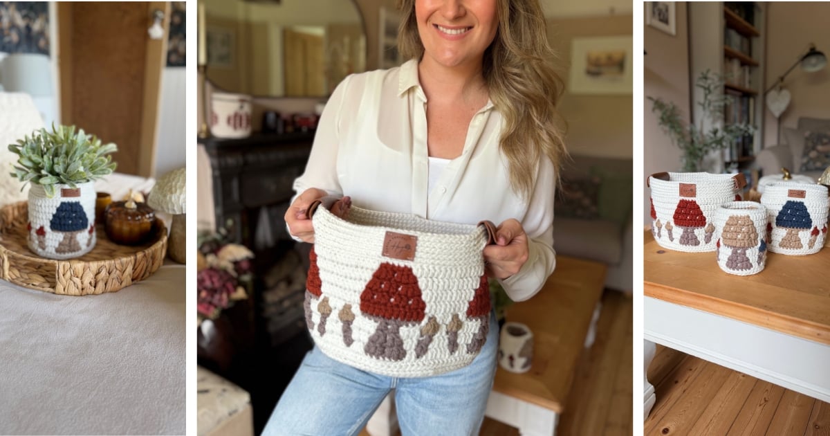 A woman holds a white crocheted basket with red and brown mushroom designs; similar crochet baskets and decor are displayed around a cozy living room.
