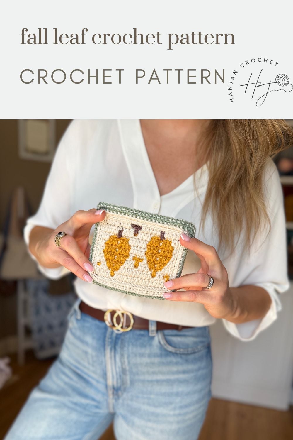 Woman holding a crocheted pouch with a fall leaf pattern, wearing a white blouse and blue jeans, text above reads “fall leaf crochet pattern.”.